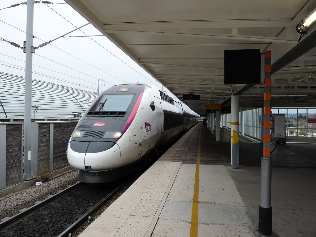 High-speed train waiting at an Avignon TGV station platform under a canopy