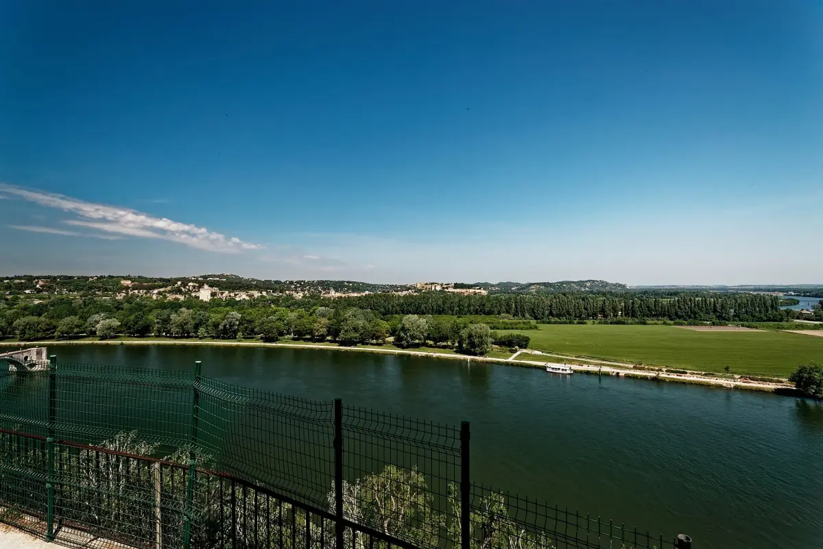 Wide blue Rhône river bend and green plain seen from the Rocher des Doms